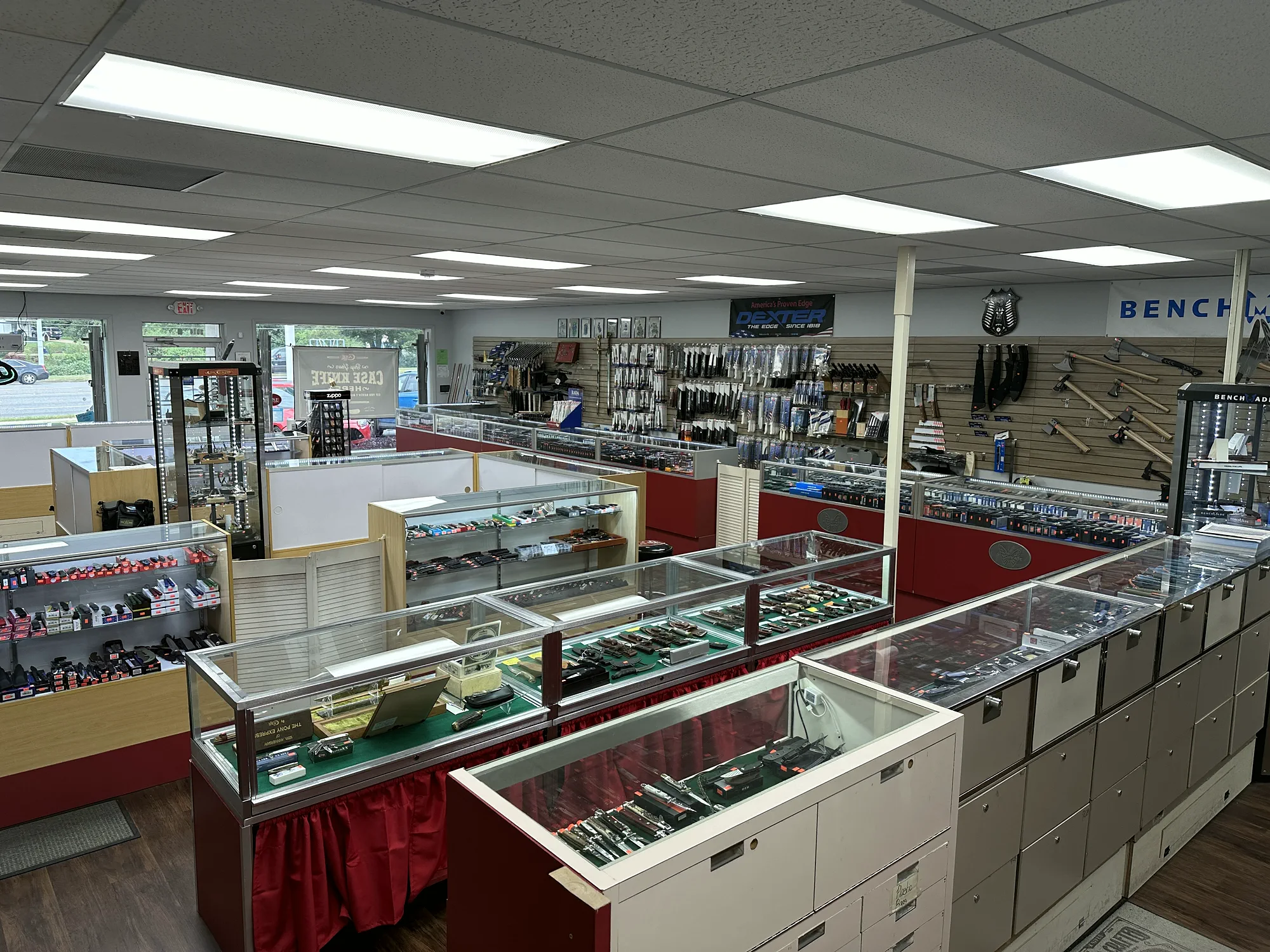 Wide view across rows of knife display cases inside Knives & More