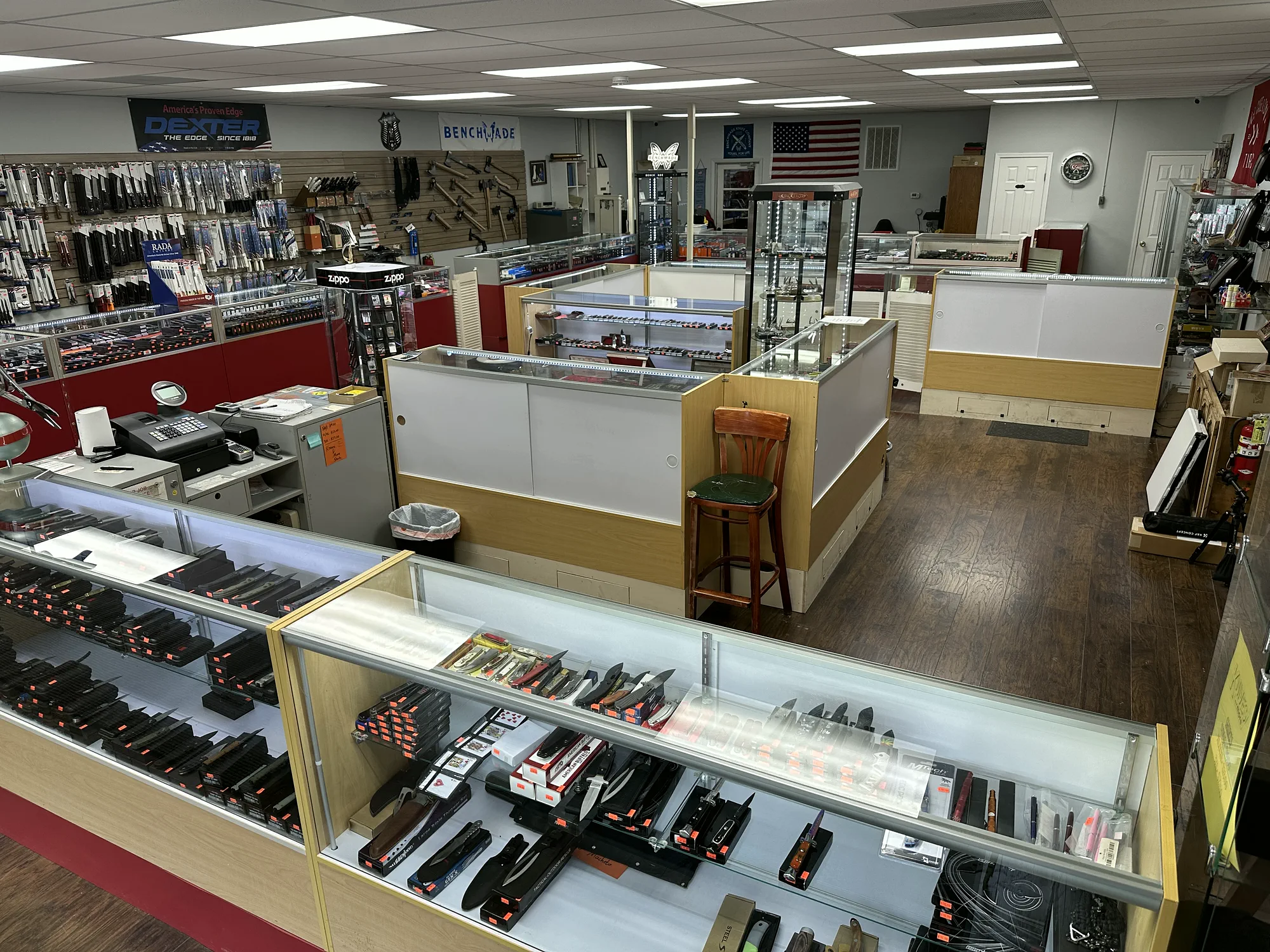 Glass cases filled with pocket knives, kitchen cutlery, and other blade-related gear